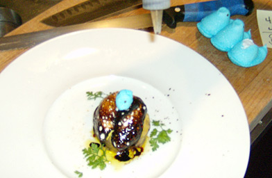 
                    Medallion of Foie Gras with two melted yellow peep bases, balsamic vinegar, and garnished with the ripped off head of a blue peep.
                                            (John Moe)
                                        