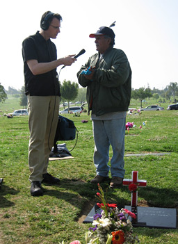 
                    Bill Radke and Tony Vasquez talk, near an Easter-decorated grave.
                                            (Suzie Lechtenberg)
                                        