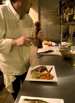 
                    Executive chef at Galleria de Paco, Steve Carpenter, grinds black pepper to finish a dish.  The gallery and restaurant in Waterloo, Iowa, serves fine food and sells Paco Rosic's aerosol artwork.
                                            (Sarah Mercier)
                                        