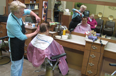 
                    Nancy cuts Eunice Inman's hair at Lovely Lady Salon on Main Street Hopkinton, Mass. Both women have lived all their life in Hopkinton and remember the days when the Boston Marathon was only run by a few hundred people.
                                            (Ian Gray)
                                        