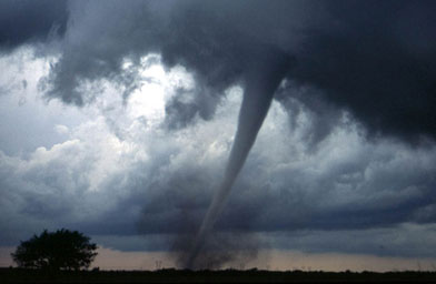 
                    One of several tornadoes observed by the VORTEX-99 team on May 3, 1999, in central Oklahoma. Note the tube-like condensation funnel, attached to the rotating cloud base, surrounded by a translucent dust cloud.
                                            (National Oceanic and Atmospheric Administration)
                                        