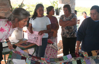 
                    Boquillas women watch neighbors bring their crafts for De Narvaez.
                                            (Michael May)
                                        