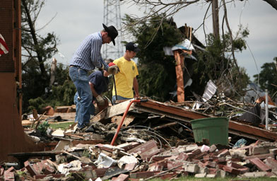
                    Residents sift through debris in Greensburg, Kan., where a massive tornado was part of a weekend of violent storms that tore across the plains.
                                            (Jim Watson / AFP / Getty Images)
                                        