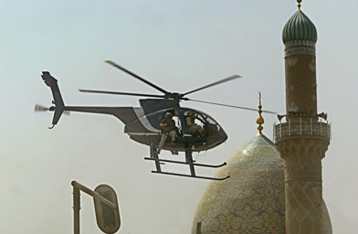 
                    A helicopter of the Blackwater security firm flies low above the scene where a roadside bomb exploded near the Iranian embassy in central Baghdad in July of 2005.
                                            (Yuri Cortez / AFP / Getty Images)
                                        