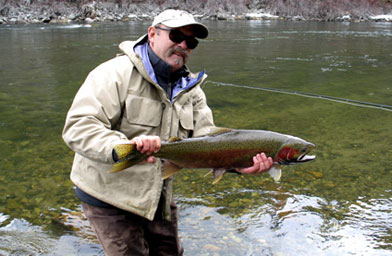 
                    Jeff Metcalf with a steelhead on the Salmon River in Idaho.
                                            (Scott Carrier)
                                        