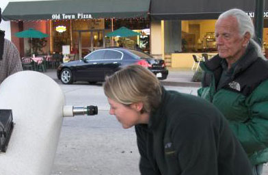 
                    John Dobson (with green jacket and white ponytail) shows a stranger the universe at a sidewalk astronomy event in Monrovia, Calif.
                                            (Jane Houston Jones)
                                        