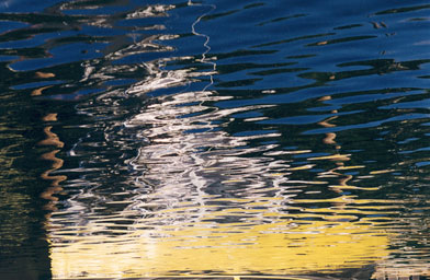 
                    "Yellow Boat Minor Chord"  Smilack took this picture of a reflection of a yellow boat.  When she looks at this, she hears the sound of a minor chord.
                                            (Marcia Smilack)
                                        