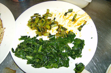 
                    Separating the stems from the leaves on a 99-cent bushel of greens made two separate dishes.
                                            (John Moe)
                                        