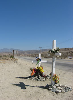 
                    Roadside memorials speak to the consequences of reckless driving on the road. Thirteen people have died in crashes along the CA-138/Pearblossom Highway in the past three years.
                                            (Eve Troeh)
                                        