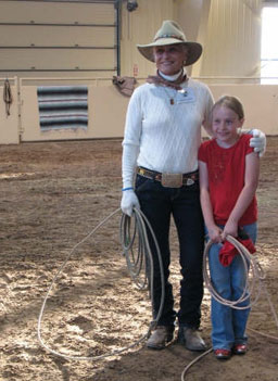 
                    Audrey Griffin of California, a longtime roper (she can "heel" a calf in no time flat!), shares some skills with a future Audrey. Audrey, who's in her 70s, said, "if my lights go out in my saddle, that's just fine with me."
                                            (Jule Gardner)
                                        