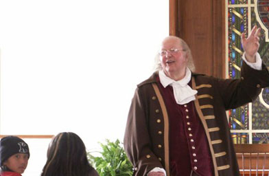 
                    Ralph Archbold, the nation's premier Benjamin Franklin reenactor, tells stories of the founding father's life to a group of fifth graders from Paradise Canyon Elementary in La Canada, Calif. The school has been sending students to Philadelphia to learn about the American Revolution for 28 years.
                                            (Freedoms Foundation)
                                        