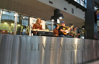 
                    Redd Volkeart plays for the audience at the Austin airport's main stage.
                                        