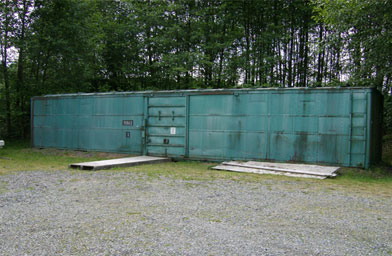 
                    Old boxcars serve as storage facilities for the shells. Per government regulation, they are set far apart from one another, "No Smoking" signs are posted outside.
                                            (John Moe)
                                        