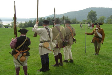 
                    Reenactors show their guns.
                                            (Jim Roberts)
                                        