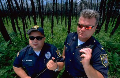 
                    Anthony J. Melchionne, a police officer (left) and Andrew Izat, a police chief, report to duty in Double Trouble, N.J.
                                            (Reprinted with permission from Reaching Climax: And Other Towns Along the American Highway. Copyright 2006 by Gary Gladstone, Ten Speed Press, Berkeley, CA. Gary Gladstone.)
                                        