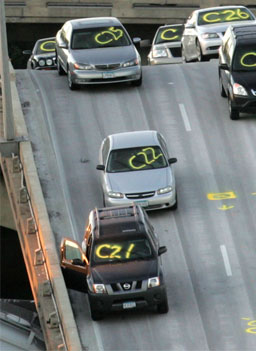 
                    Cars that were traveling on the I-35W bridge in Minneapolis, Minn., when it collapsed. Officials marked them on August 2, 2007. The eight-lane steel and concrete bridge spanning the Mississippi River near the city's downtown was undergoing repair work when it collapsed during the evening rush hour.
                                            (Mark Wilson / Getty Images)
                                        