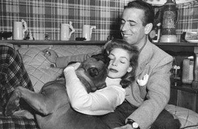 
                    Lauren Bacall and husband Humphrey Bogart at home, ca. 1948, with their dog.
                                            (The Margaret Herrick Library)
                                        