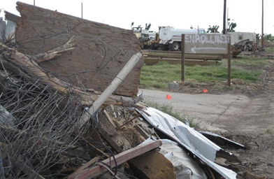 
                    The sign for student enrollment stands among debris.
                                            (Jon Cyphers)
                                        