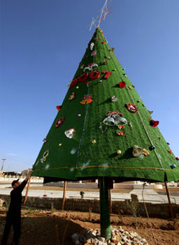 
                    An Iraqi decorates a Christmas tree in the northern Iraqi city of Arbil on December 21, 2006.
                                            (Safin Hamed / AFP / Getty Images)
                                        