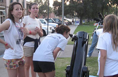 
                    Participants in the Cancer Walk-a-Thon stop by to check out the moon's craters.  One woman said, "It looks like rain on the dirt, right after it rains and it's got all those little holes in it."
                                            (Jane Houston Jones)
                                        