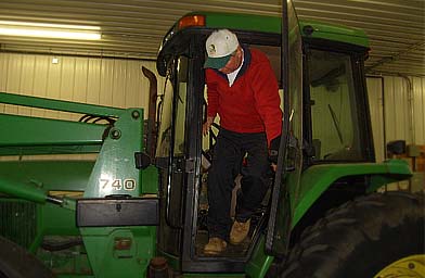 
                    Congressional Candidate Jim Ogonowski stepping out of his hay baler.
                                            (Sean Cole)
                                        