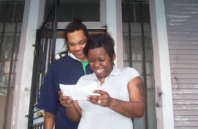 
                    Kara Keyes and her husband Ronald looking at a photo of their dog Crown when they found out he was rescued.
                                            (Kara Keyes)
                                        