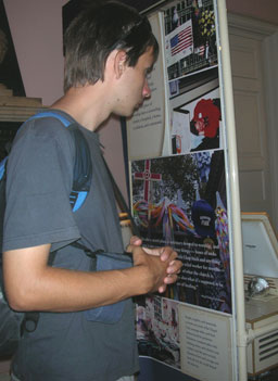 
                    A visitor looks at one of the many displays around the periphery of St. Paul's Chapel. It describes the role that the church played on 9/11 and the days after.
                                            (Ann Heppermann)
                                        