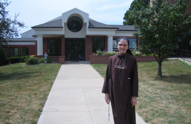 
                    Sister Loretta outside the convent chapel. The rope around her waist is similar to the rope St. Francis wore. It has three knots meant to signify the vows of poverty, chastity and obedience that the Sisters of St. Francis take.
                                            (Kelly McEvers)
                                        