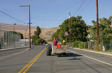 
                    Thompson drives his tractor between his roadside produce shop and a nearby farm. He says it's a great marketing tool. When the tractor pulls up with fresh fruit, people swarm it.
                                            (John Moe)
                                        