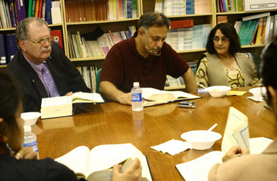 
                    Rick Isserman (left), Khalid Shah and his wife Gul Shah participate in a meeting of Confluence of Faith.
                                            (Mike Sherwin)
                                        