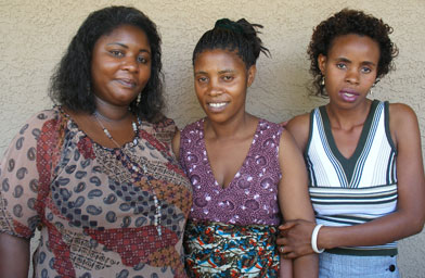 
                    Jeanne, Jean and Claudine stand outside the two women's apartment in Phoenix.  Jean and Claudine came to Phoenix from the refugee camps in Zambia a little over a year ago.
                                            (Ann Heppermann and Kara Oehler)
                                        