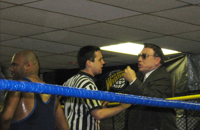 
                    Johnny Fabulous argues with a ref while Bionic Dan Bidondi looks on.
                                            (Amanda Bidondi)
                                        