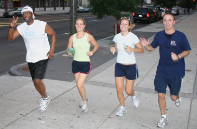 
                    Sunday Morning Breakfast resident Craig feels the peace on an early morning jog through downtown Philadelphia with Back On My Feet volunteers Chris Garrett, Jessica Doty and Andy Marr.
                                            (Wylie Belasik)
                                        