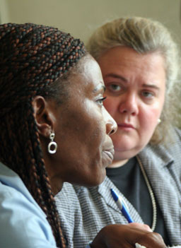 
                    Liberian TRC Commissioner Massa Washington with Minnesota Advocates for Human Rights Executive Director Robin Phillips at the signing of the Memorandum of Understanding, also known as an MOU.
                                            (photog)
                                        