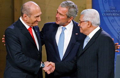 
                    (L to R) Israeli Prime Minister Ehud Olmert, Palestinian President Mahmud Abbas and U.S. President George W. Bush shake hands at the beginning of the opening session of the Annapolis Conference at the U.S. Naval Academy November 27, 2007 in Annapolis, Maryland.
                                            (Chip Somodevilla/Getty Images)
                                        