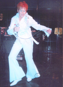 
                    Jan McDonald, in a jumpsuit, performing as Elvis.
                                            (John Moe)
                                        