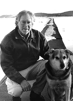 
                    Author John Smolens and his dog, Dammie.  Frozen Lake Superior looms in the background.
                                            (John Smolens)
                                        