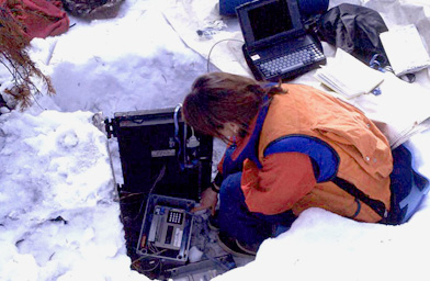 
                    Barbara Bentz at a field site in Idaho downloading temperature machines.
                                            (Jim Vandygriff)
                                        