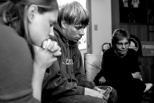 
                    Obama Campaign field organizer Katie Malkin, Luke Haffner, and Irene Pfannkuch (left to right) listen to Senator Obama over a cell phone speakerphone.  The Senator addressed pre-caucus events across the state through this one-way call.
                                            (Sarah Mercier)
                                        