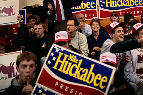 
                    Supporters of Republican presidential hopeful Mike Huckabee wave signs during a rally at New England College Jan. 4, 2008 in Henniker, N.H. Huckabee's surprise win in the Iowa caucuses has propelled the ordained Baptist minister into the national spotlight.
                                            (Chip Somodevilla / Getty)
                                        