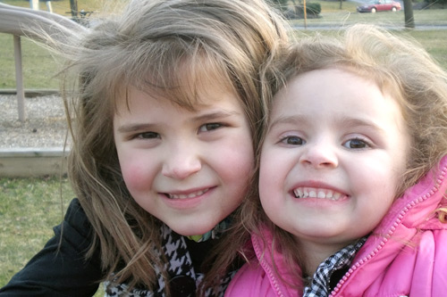 
                    A present-day photo of the two Case Sisters.  (Lillian is on the left.) Lillian turns five this month, a day after the anniversary of the start of the Iraq War.
                                            (Courtesy Scot Case)
                                        