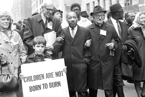 
                    Dr. Benjamin Spock (second from left), Rev. Martin Luther King, Jr. (center), Father Frederick Reed and union leader Cleveland Robinson lead a rally protesting U.S. involvement in Vietnam in New York on March 16, 1967.
                                            (AFP/Getty Images)
                                        