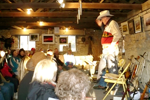 
                    Cowboy Poet "Lariat" Ron Wilson entertains between burns.
                                            (Sylvia Gross)
                                        