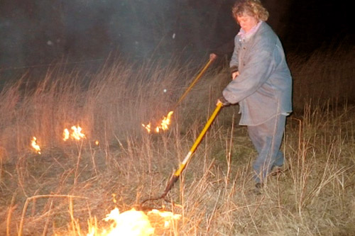 
                    Kristy Wright controls the last bit of fire by the road, staying on the field until the last bit of fire is done smoldering.
                                            (Sylvia Gross)
                                        