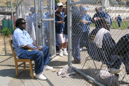 
                    Inmate Bernard Moss holds the line at the gate.
                                            (Nancy Mullane)
                                        
