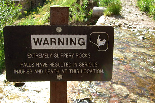 
                    A sign on the trail warns hikers away from the edge.
                                            (Michael May)
                                        