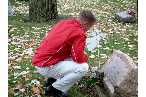 
                    Doug contemplates Dawn's grave, his childhood sweetheart and suicide victim. He was angry at her after her suicide in 1987, and refused to go to her funeral or burial. Years later, Doug considered taking his own life. Instead, he went to the cemetery to visit the grave of a friend and stumbled upon Dawn's grave. It was a cathartic moment when he decided that he would commit his life to battling suicide and depression.
                                            (Desiree Cooper)
                                        