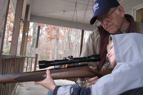 
                    Nancy's father teaches her son how to use a rifle.
                                            (Nancy French)
                                        