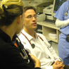 ER interns and residents discuss patient care.