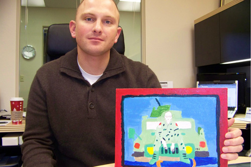 
                    Jason Faler, of Portland, Ore., holds a portrait that Mustafa's daughter painted for him. The soldier started the Checkpoint One Foundation to help get Iraqi and Afghani interpreters to the United States.
                                            (Anna King)
                                        